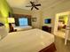 Well lit bedroom with a view through the doorway, featuring two beds and neutral decor at 1350 Centre Court Ridge Dr # 401, Reunion, FL 34747