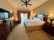 Well-lit bedroom features a comfortable king-size bed, dark wood furniture, and balcony access at 1350 Centre Court Ridge Dr # 401, Reunion, FL 34747