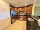 This kitchen features stainless steel appliances and dark wood cabinets that nicely complement the tile flooring at 1350 Centre Court Ridge Dr # 401, Reunion, FL 34747