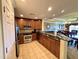 This kitchen features stainless steel appliances and dark wood cabinets that nicely complement the tile flooring at 1350 Centre Court Ridge Dr # 401, Reunion, FL 34747