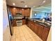 This kitchen features stainless steel appliances and dark wood cabinets that nicely complement the tile flooring at 1350 Centre Court Ridge Dr # 401, Reunion, FL 34747