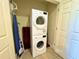 Compact laundry area features a stacked washer and dryer set for efficient space utilization at 1350 Centre Court Ridge Dr # 401, Reunion, FL 34747