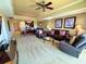 This living room features a ceiling fan, modern lighting, and an open floor plan at 1350 Centre Court Ridge Dr # 401, Reunion, FL 34747