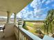 Scenic balcony view of golf course, building, and blue sky at 1350 Centre Court Ridge Dr # 401, Reunion, FL 34747