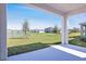 Covered patio overlooking green backyard with a tranquil pond and neighborhood views at 1503 August Gray Dr, Kissimmee, FL 34744