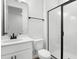 Clean and modern bathroom with a glass-enclosed shower, white vanity, and dark fixtures at 1503 August Gray Dr, Kissimmee, FL 34744