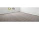 Spacious bedroom featuring neutral carpeting, white walls, and bright natural light at 1503 August Gray Dr, Kissimmee, FL 34744