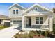 Charming two-story home with stone accents, a covered porch, and a two-car garage on a sunny day at 1503 August Gray Dr, Kissimmee, FL 34744