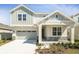 Beautiful two-story home with stone accents, a covered porch, and a two-car garage at 1503 August Gray Dr, Kissimmee, FL 34744