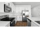 Bright kitchen with white cabinets, stainless steel appliances, quartz countertops, and wood flooring at 1503 August Gray Dr, Kissimmee, FL 34744