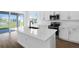 Bright kitchen featuring white cabinets, stainless steel appliances, a large island, and wood flooring at 1503 August Gray Dr, Kissimmee, FL 34744
