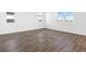 Spacious living space featuring wood-look tile flooring and plenty of natural light from the windows at 1503 August Gray Dr, Kissimmee, FL 34744