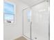 Bright bathroom featuring glass enclosed shower and window with outdoor view at 1509 August Gray Dr, Kissimmee, FL 34744