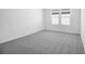 Bright bedroom featuring neutral carpet, white walls, and double window with natural light at 1509 August Gray Dr, Kissimmee, FL 34744
