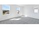 Bright bedroom featuring neutral carpet, white walls, and three windows with view at 1509 August Gray Dr, Kissimmee, FL 34744