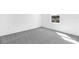 Bright bedroom featuring neutral carpet, white walls, and window with view at 1509 August Gray Dr, Kissimmee, FL 34744