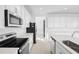 Bright white kitchen featuring stainless steel appliances, ample cabinet space, and a sleek kitchen island at 1509 August Gray Dr, Kissimmee, FL 34744