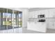 Bright kitchen with stainless steel appliances, island, and sliding doors leading to a patio at 1509 August Gray Dr, Kissimmee, FL 34744