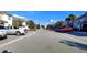 Street view of a residential community showing parked cars and well-maintained landscaping on a sunny day at 1596 Moon Valley Dr, Davenport, FL 33896