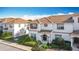 Charming two-story home featuring a red tile roof, stucco walls, and a well-manicured front yard at 1596 Moon Valley Dr, Davenport, FL 33896