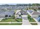 Aerial view of home's front elevation showcases the lawn, landscaping, and two-car garage at 1944 Harvest Landing Cir, Lakeland, FL 33810