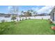Expansive backyard with lush green grass, a privacy fence, and manicured landscaping at 1944 Harvest Landing Cir, Lakeland, FL 33810
