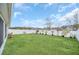 Spacious backyard with a well-maintained lawn, mature trees, and privacy fencing at 1944 Harvest Landing Cir, Lakeland, FL 33810