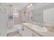 Bathroom featuring double sinks, a bathtub with shower, and beach-themed decor at 1944 Harvest Landing Cir, Lakeland, FL 33810
