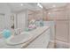 Bathroom featuring double sinks, a large mirror, and a glass-enclosed shower at 1944 Harvest Landing Cir, Lakeland, FL 33810