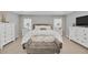 This well-lit main bedroom features coordinating furniture, a neutral color palette, and two large windows at 1944 Harvest Landing Cir, Lakeland, FL 33810