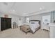 Beautifully staged main bedroom features a tray ceiling, wood-look flooring, and neutral color palette at 1944 Harvest Landing Cir, Lakeland, FL 33810