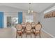 Elegant dining room with a wooden table, upholstered chairs, and sliding doors to a screened patio at 1944 Harvest Landing Cir, Lakeland, FL 33810