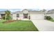 Charming single-story home boasts a well-manicured lawn, tidy landscaping, and a two-car garage at 1944 Harvest Landing Cir, Lakeland, FL 33810