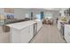 Open kitchen with island and stainless steel dishwasher, flowing into the dining and living area at 1944 Harvest Landing Cir, Lakeland, FL 33810