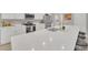 Bright kitchen island with a modern sink, pendant lighting, and white cabinets at 1944 Harvest Landing Cir, Lakeland, FL 33810