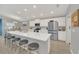 Modern kitchen featuring an island with barstool seating, stainless steel appliances, and white cabinetry at 1944 Harvest Landing Cir, Lakeland, FL 33810