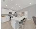 Modern kitchen featuring an island with barstool seating, stainless steel appliances, and white cabinetry at 1944 Harvest Landing Cir, Lakeland, FL 33810