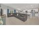 Spacious living room featuring an oversized gray sectional sofa, white walls, and an open floorplan at 1944 Harvest Landing Cir, Lakeland, FL 33810
