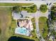 Aerial view of the community clubhouse with a pool, lounge chairs, and parking surrounded by green landscape at 2203 Key West Ct # 435, Kissimmee, FL 34741