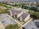 Aerial view of apartment building with parking lot, surrounded by lush landscaping and nearby residential area at 2203 Key West Ct # 435, Kissimmee, FL 34741