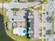 Aerial view of an apartment complex featuring a swimming pool and surrounding parking areas at 2203 Key West Ct # 435, Kissimmee, FL 34741