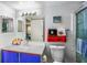 Compact bathroom with a single sink vanity, a standard toilet, a framed mirror and a shower with glass doors at 2203 Key West Ct # 435, Kissimmee, FL 34741