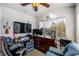 Well-lit bedroom with a window, a ceiling fan, a large dresser, a desk and a comfortable armchair at 2203 Key West Ct # 435, Kissimmee, FL 34741