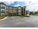 Apartment building with colorful facades, street parking and green space at 2203 Key West Ct # 435, Kissimmee, FL 34741