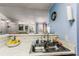 Charming kitchen area showcasing a stainless steel double sink, marble countertops, and an inviting view to the living space at 2203 Key West Ct # 435, Kissimmee, FL 34741