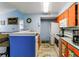 Charming kitchen featuring orange cabinets, stainless steel appliances, and a breakfast bar at 2203 Key West Ct # 435, Kissimmee, FL 34741