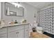 Modern bathroom featuring granite counters, a dark framed mirror and black and white shower curtain at 2849 Shelburne Way, St Cloud, FL 34772