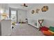 Playful bedroom featuring a colorful ceiling fan, crib, toys, and stylish décor at 2849 Shelburne Way, St Cloud, FL 34772
