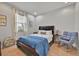 Cozy bedroom with a comfortable bed, chair, window and tiled floor at 2849 Shelburne Way, St Cloud, FL 34772