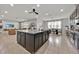 Modern kitchen with a large center island, stainless appliances, and an open layout to the dining area at 2849 Shelburne Way, St Cloud, FL 34772
